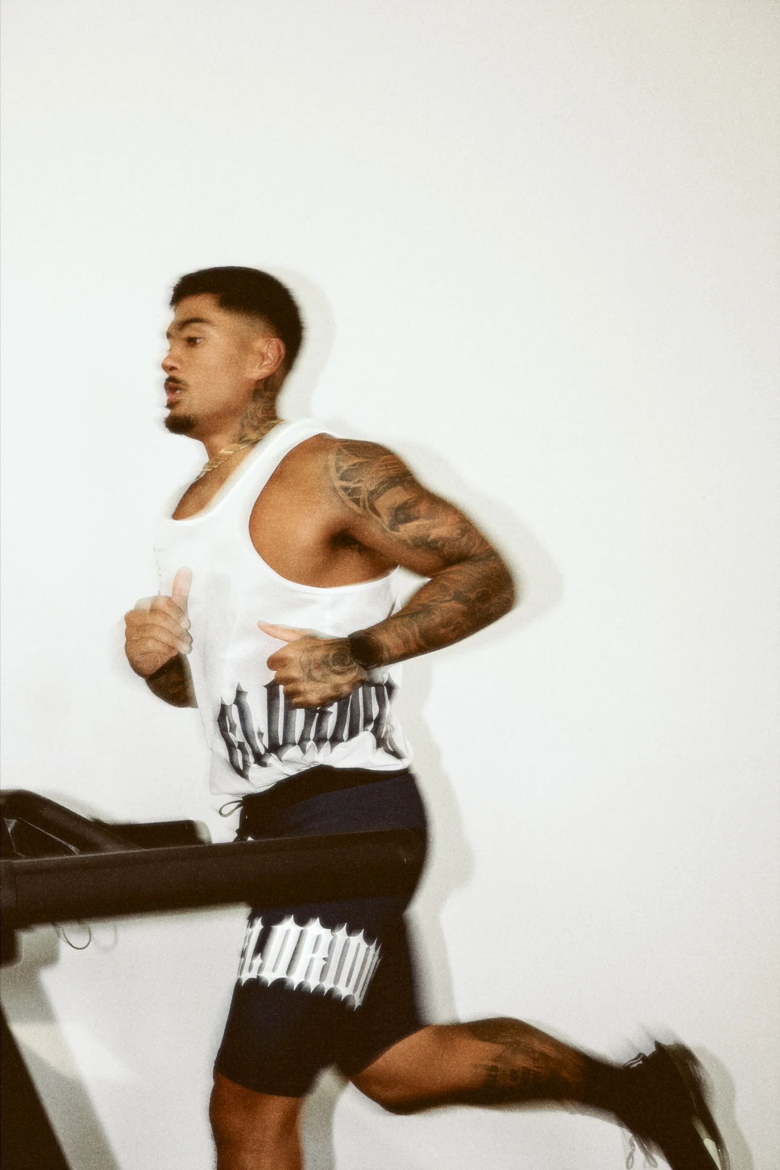 Glorious athlete running on a treadmill in the supplied training kit