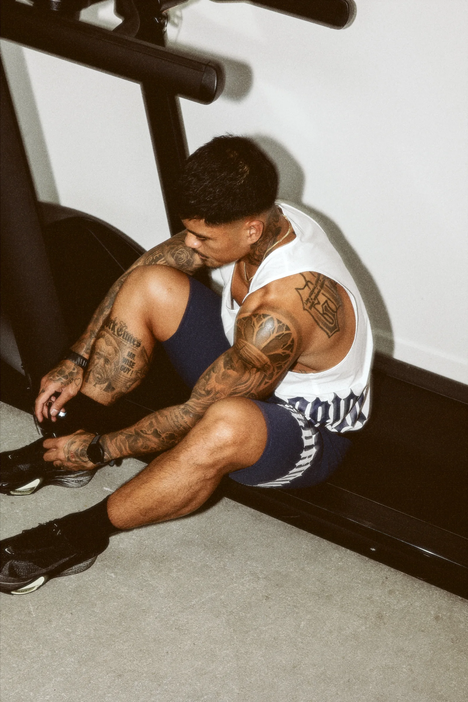The Glorious athlete preparing beside the treadmill